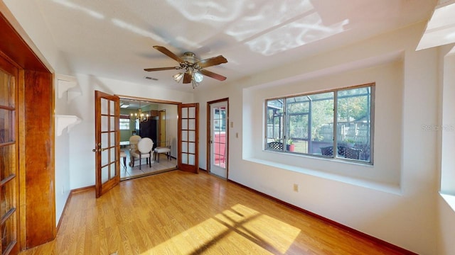 unfurnished room with light hardwood / wood-style flooring, french doors, and ceiling fan