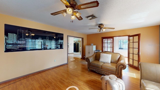 unfurnished living room with hardwood / wood-style floors, a textured ceiling, and ceiling fan