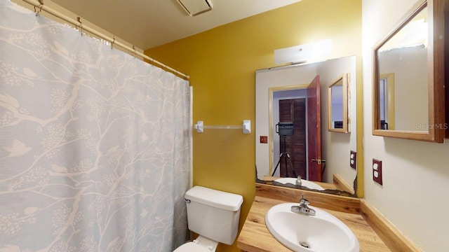 bathroom with toilet, hardwood / wood-style floors, and sink