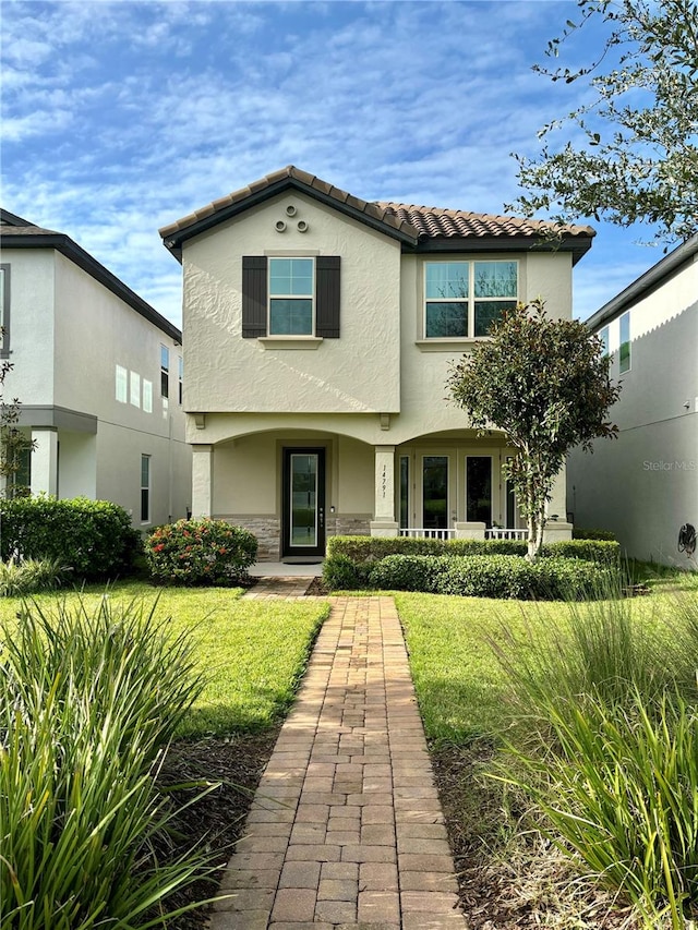 mediterranean / spanish-style home featuring a front lawn