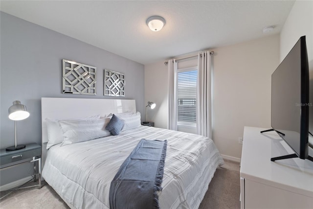 bedroom featuring a textured ceiling and carpet flooring