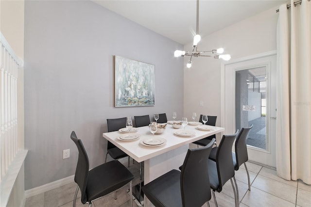 tiled dining space featuring an inviting chandelier