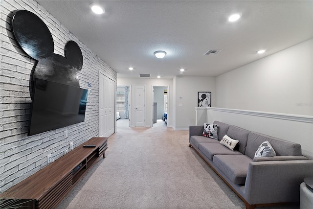 living room featuring a textured ceiling and light colored carpet