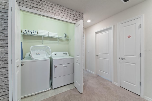 laundry room featuring light carpet and washing machine and dryer