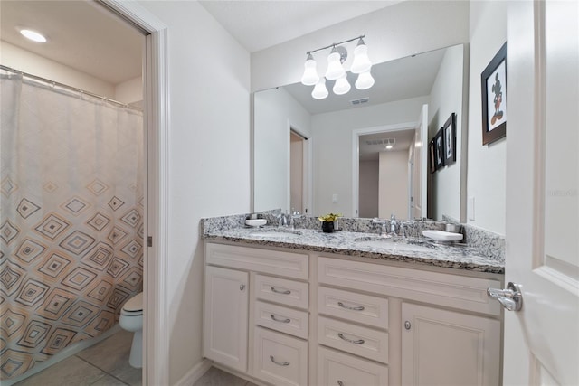 bathroom featuring vanity, toilet, and tile patterned floors