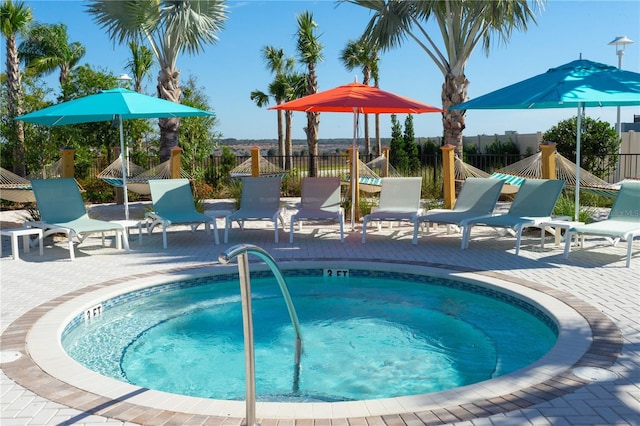 view of swimming pool featuring a patio and a community hot tub