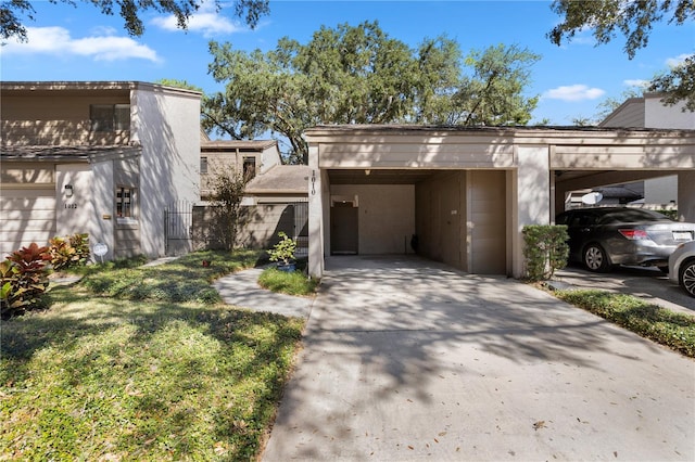 view of front of property with a front yard and a carport