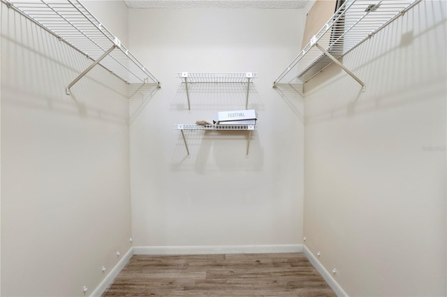 walk in closet featuring hardwood / wood-style floors