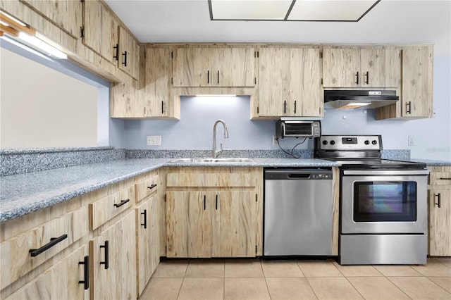 kitchen featuring sink, light brown cabinets, stainless steel appliances, and light tile patterned floors