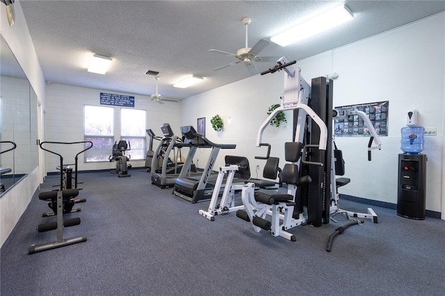 gym featuring ceiling fan and a textured ceiling