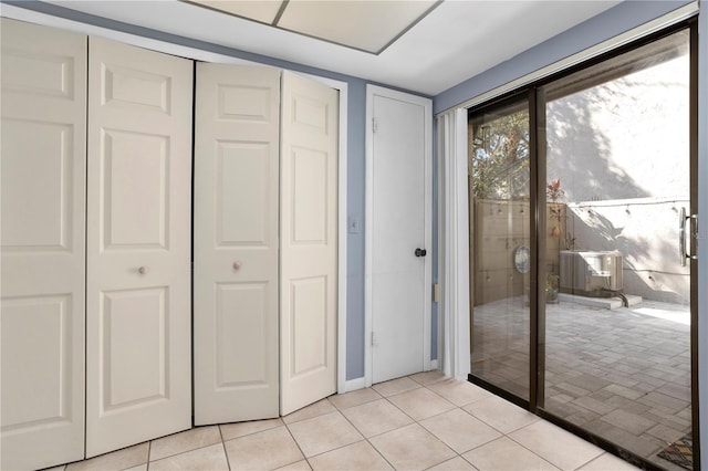 unfurnished bedroom featuring multiple closets and light tile patterned floors