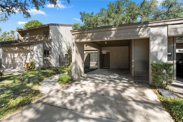 exterior space with a garage and a carport