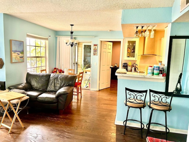 living room with a textured ceiling and dark wood-type flooring