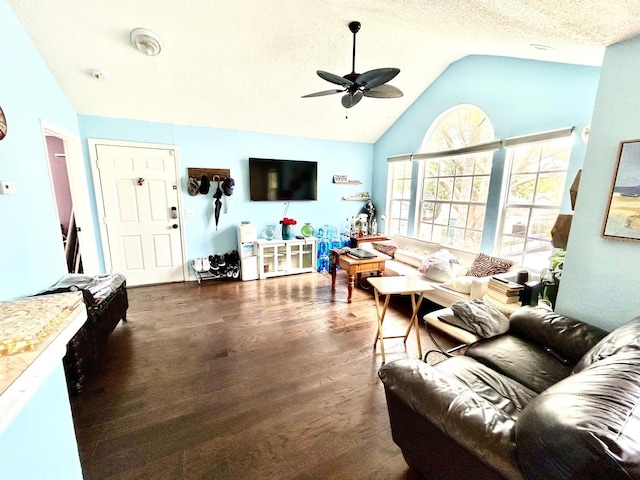 living room with lofted ceiling, dark wood-type flooring, a textured ceiling, and ceiling fan