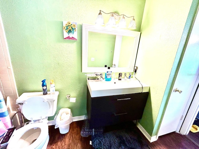 bathroom featuring vanity, toilet, and wood-type flooring