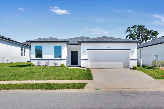 view of front facade featuring a front yard and a garage