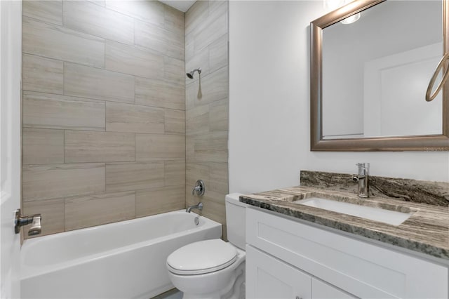 full bathroom featuring vanity, tiled shower / bath combo, and toilet