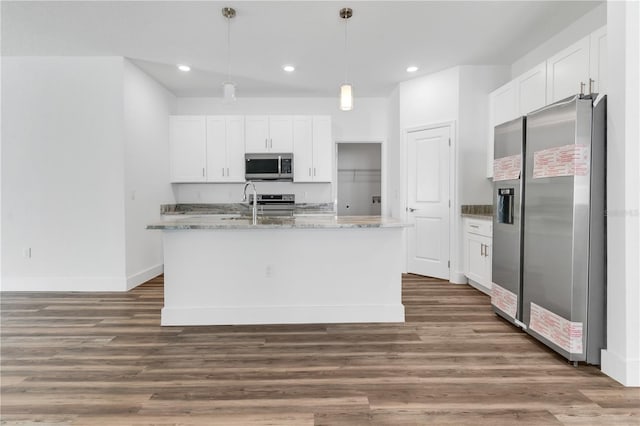 kitchen with a kitchen island with sink, stainless steel appliances, and white cabinetry