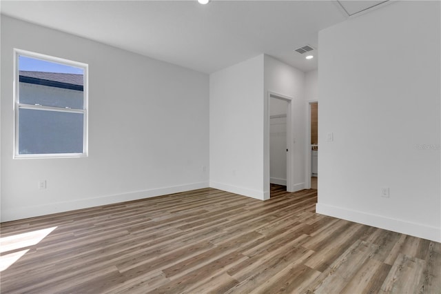 spare room featuring light hardwood / wood-style flooring and a wealth of natural light