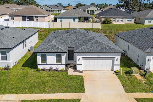 view of front facade with a front yard and a garage