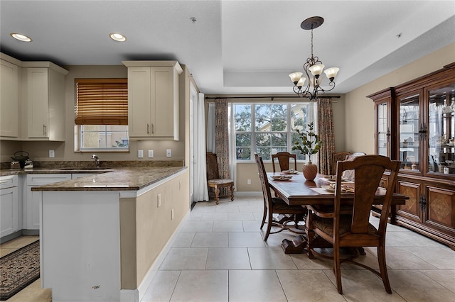 kitchen featuring pendant lighting, a notable chandelier, sink, and plenty of natural light