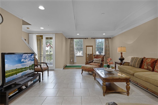 tiled living room with ornamental molding and plenty of natural light