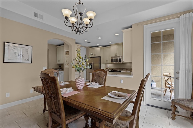 tiled dining area with an inviting chandelier