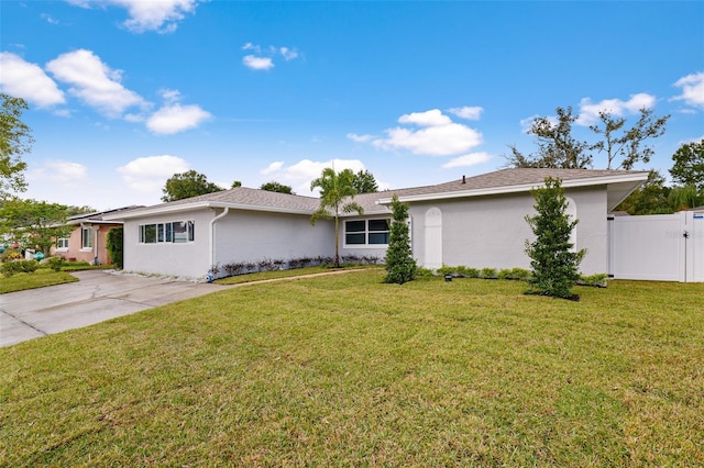 single story home featuring a front lawn