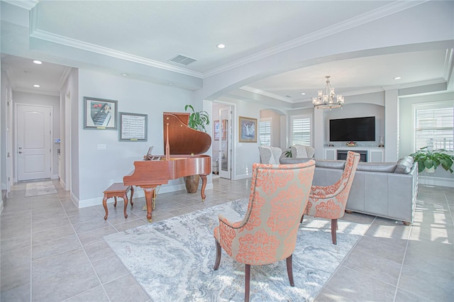 living room featuring crown molding, a notable chandelier, and plenty of natural light