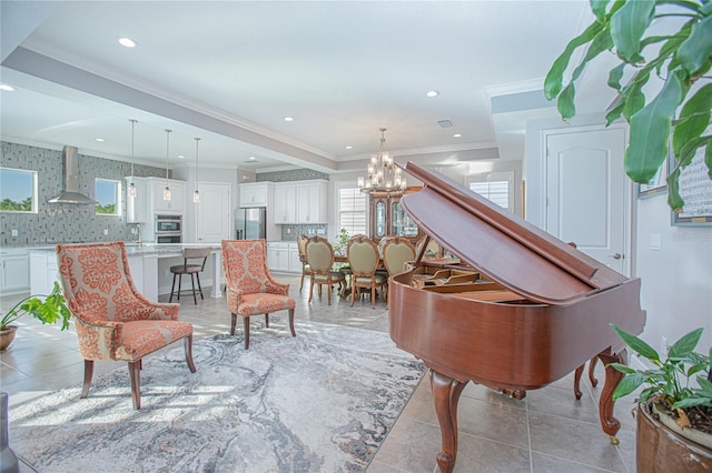 sitting room featuring crown molding, a chandelier, and light tile patterned floors