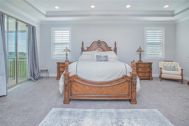 carpeted bedroom featuring crown molding, access to exterior, and a tray ceiling