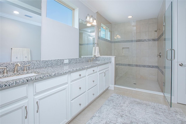 bathroom with vanity, crown molding, a shower with shower door, and tile patterned floors