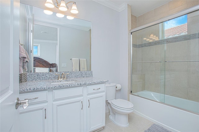 full bathroom with combined bath / shower with glass door, toilet, ornamental molding, vanity, and tile patterned flooring