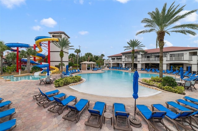 view of pool featuring a patio and a water slide