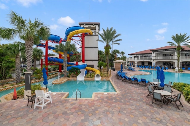 view of swimming pool featuring a patio and a water slide