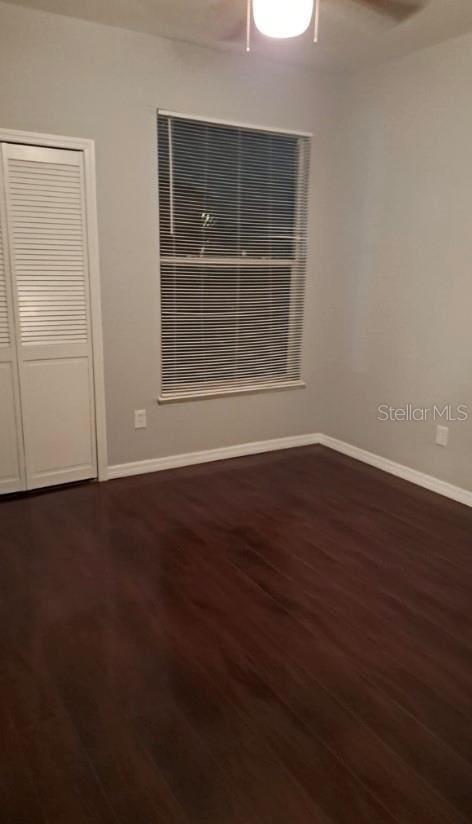 spare room with ceiling fan and dark hardwood / wood-style flooring