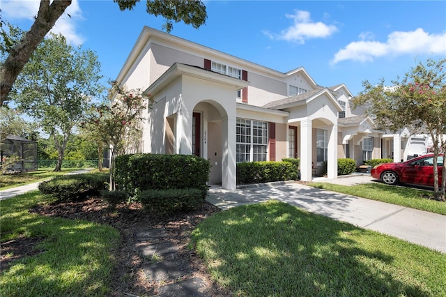 mediterranean / spanish house featuring a front lawn