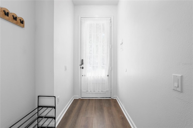 entryway with baseboards and dark wood-style floors