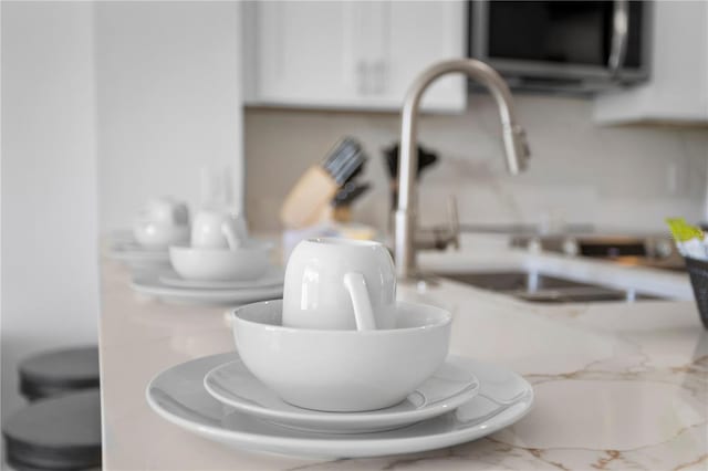room details with stainless steel microwave and white cabinetry