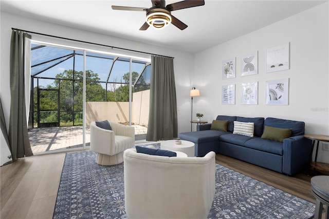 living room featuring hardwood / wood-style floors and ceiling fan