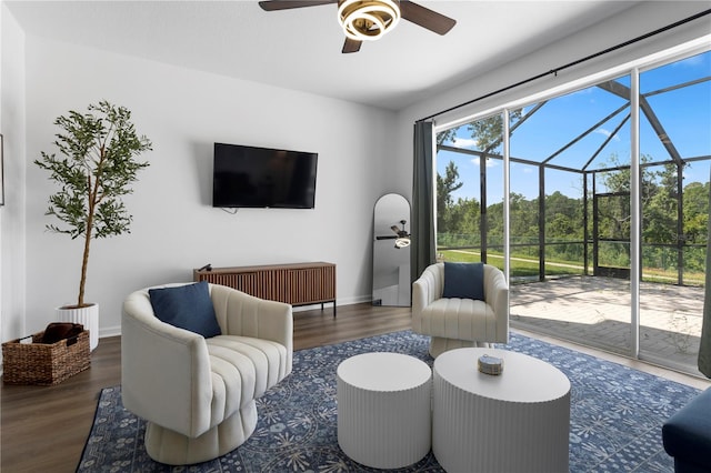 living room featuring ceiling fan and dark hardwood / wood-style floors