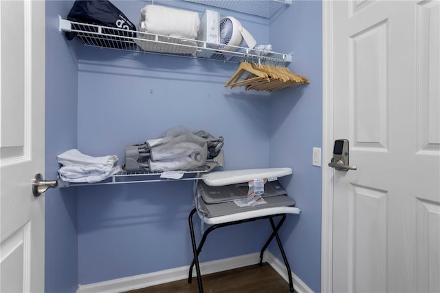 walk in closet with wood finished floors