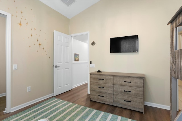 bedroom featuring lofted ceiling and dark hardwood / wood-style floors