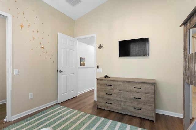 bedroom featuring baseboards, lofted ceiling, visible vents, and dark wood-style floors