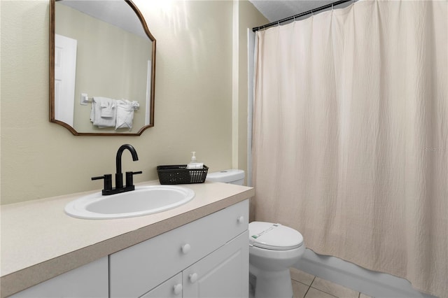 bathroom with tile patterned flooring, toilet, and vanity