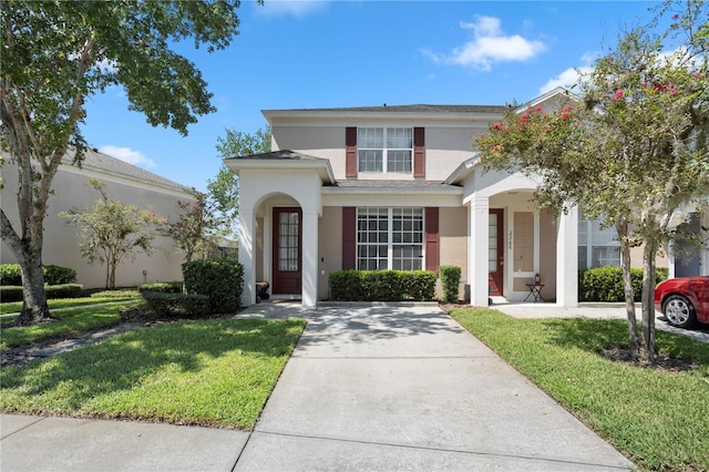 view of front of house with a front lawn and stucco siding