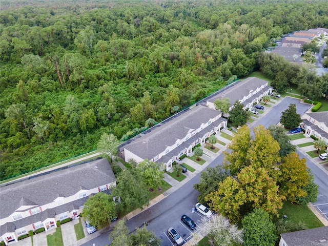 birds eye view of property featuring a residential view and a wooded view