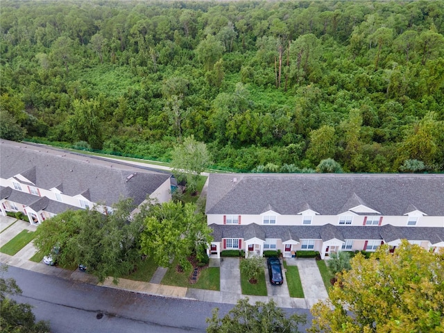 drone / aerial view featuring a wooded view