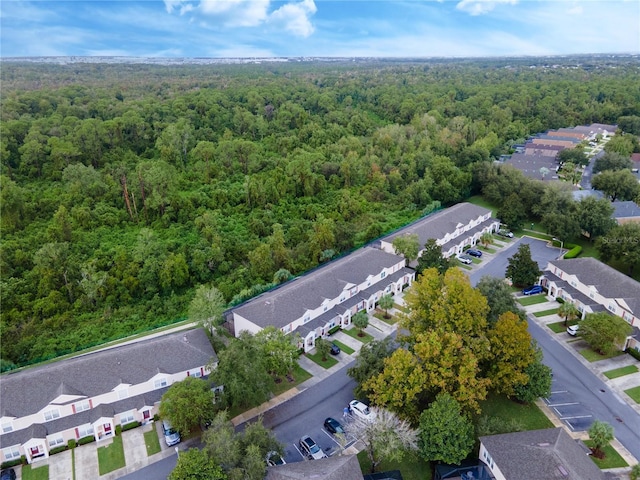drone / aerial view with a residential view and a wooded view