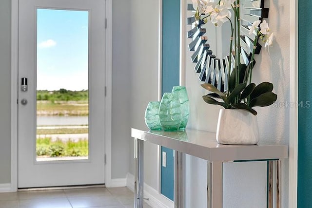 doorway to outside with a healthy amount of sunlight and light tile patterned flooring